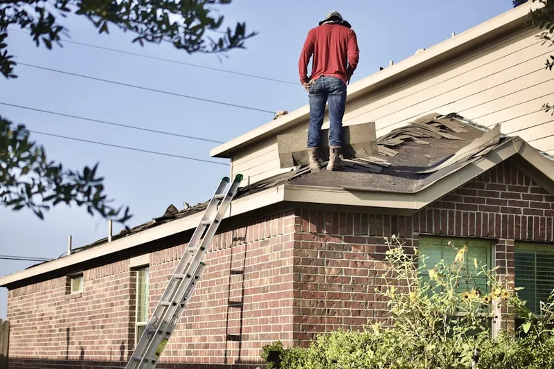 Professional roofer working on a residential roof in Penllyn